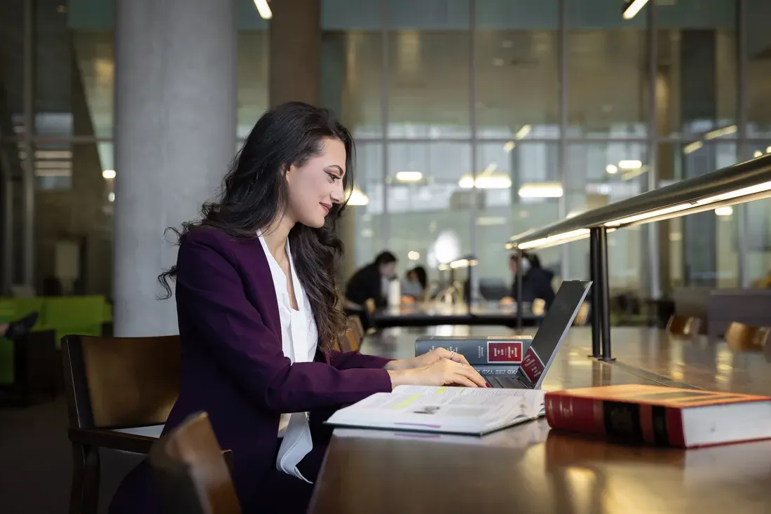 Law student Omnia Shedid doing work in the College of Law Library.